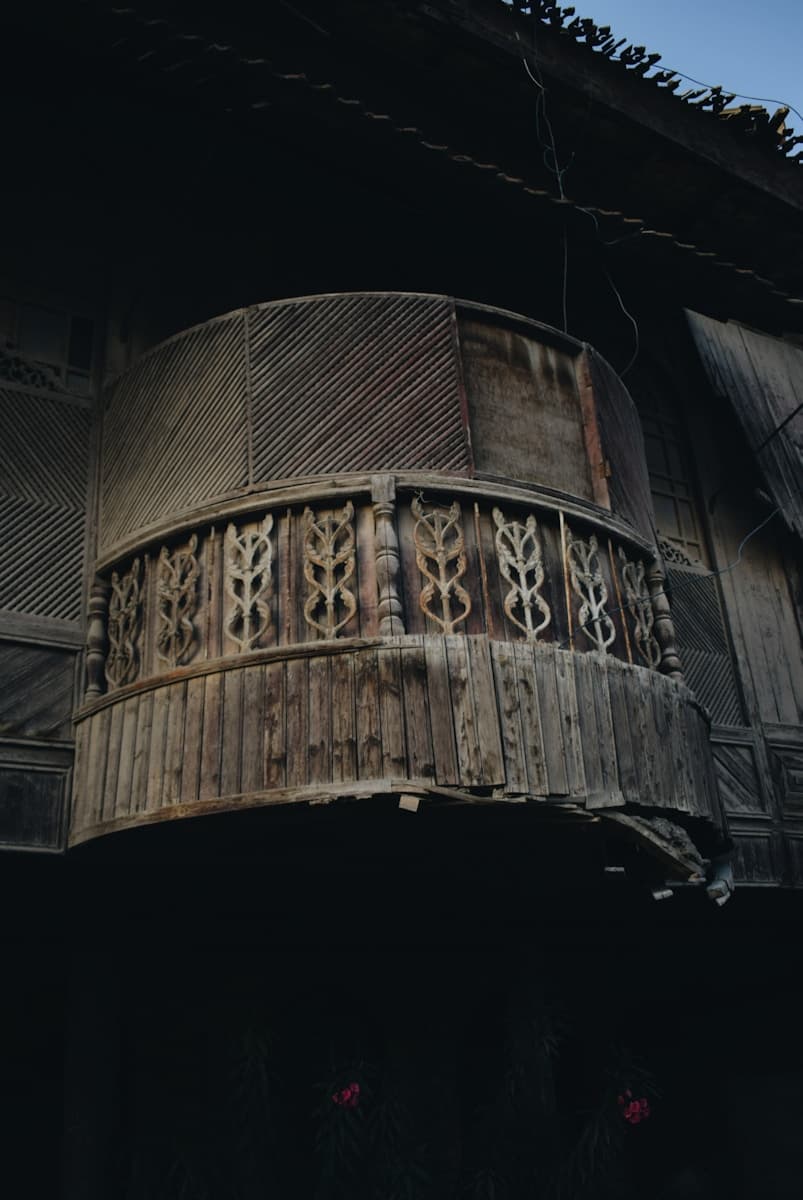 an old building with a balcony and a clock on it